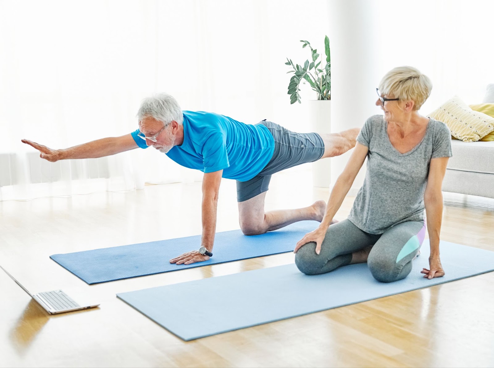 an older couple is doing low-impact yoga to help stay fit as seniors.