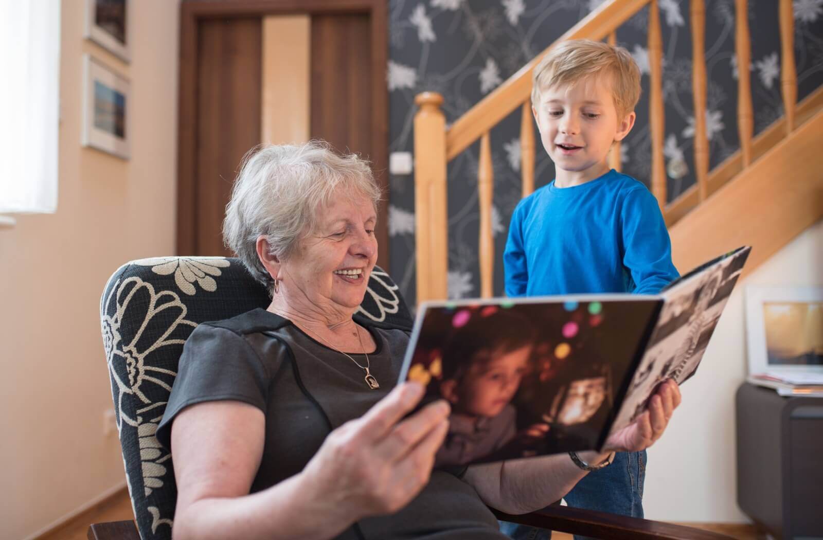 grandkid showing their gift to their grandparent they got for grandparent day